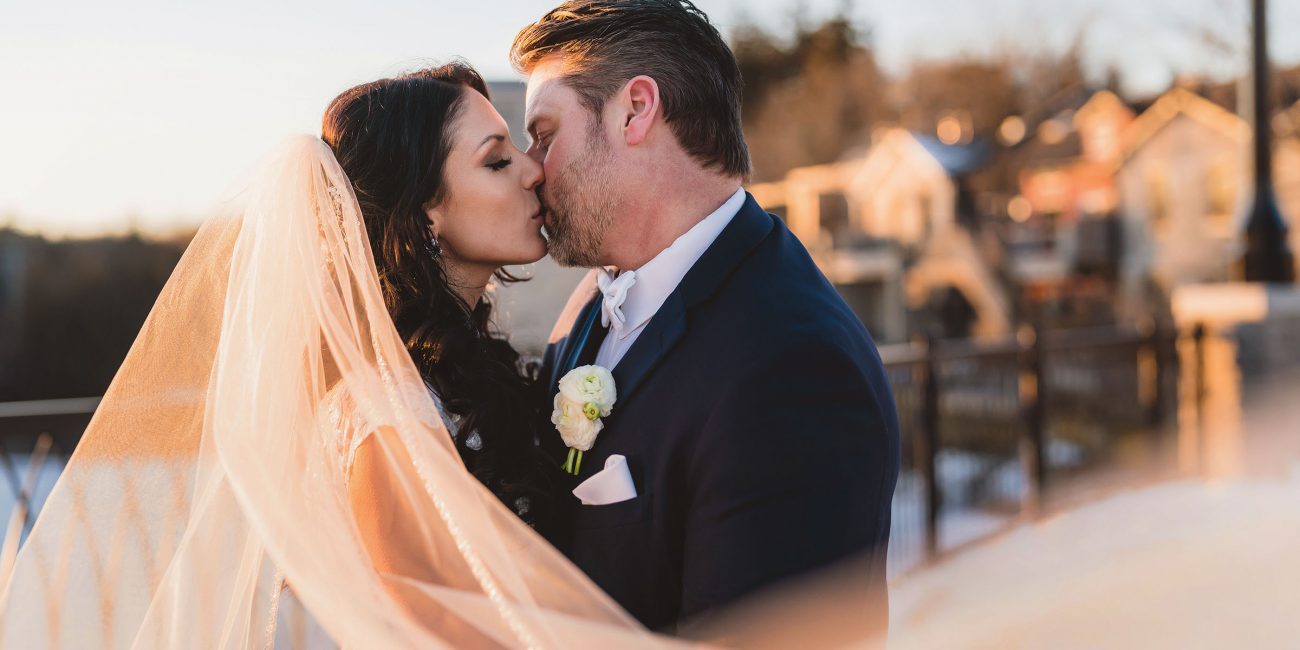 A bride and Groom kissing during Golden Hour